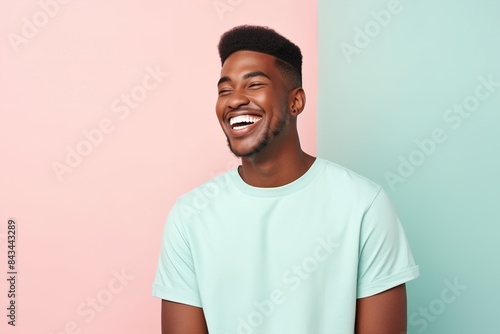 A man with a green shirt is smiling and laughing