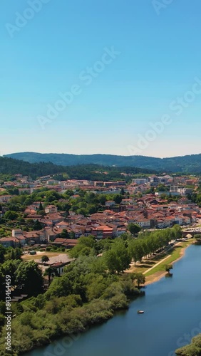 Small town near a lake with mountains - Drone establishing shot. Shot in Ponte de Lima, Viana do Castelo district, Portugal, Europe. photo