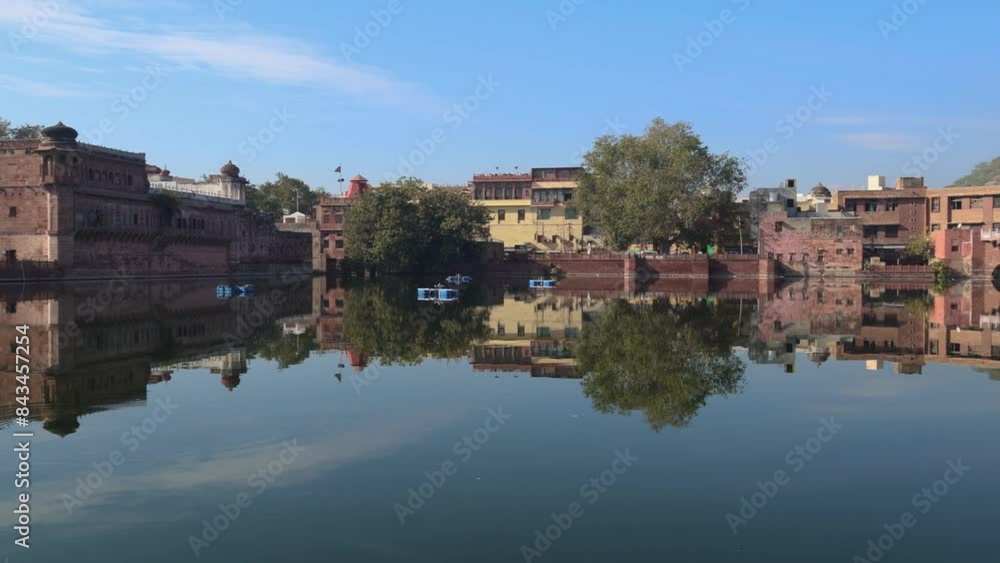pristine lake with water reflection of houses around and blue sky at morning pristine lake with water reflection of houses around and blue sky at morning