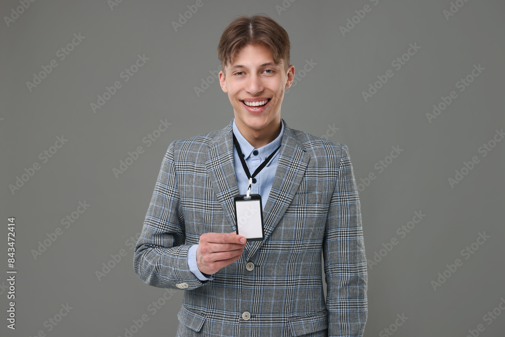 Happy man with blank badge on grey background Happy man with blank badge on grey background