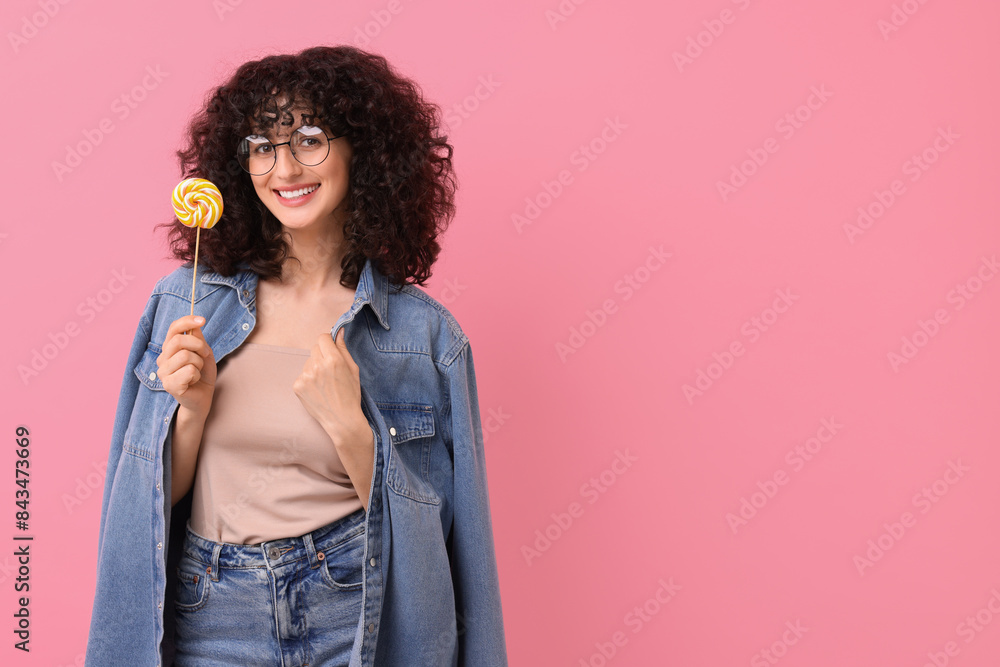 Beautiful woman with lollipop on pink background, space for text Beautiful woman with lollipop on pink background, space for text
