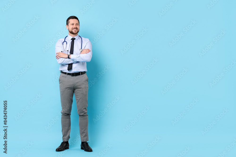 Smiling doctor with stethoscope on light blue background. Space for text Smiling doctor with stethoscope on light blue background. Space for text