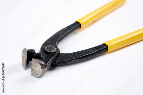 Nippers with yellow plastic handle on an isolated background