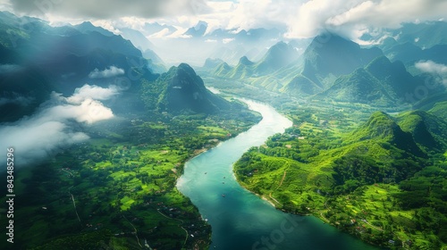 A breathtaking aerial view of a misty forested valley with a meandering river cutting through lush greenery.