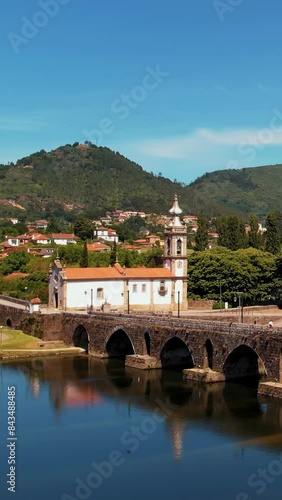 Travel in Portugal - discovering an ancient European village - church and historic stone bridge over a river.
Shot in Ponte de Lima, Portugal, Europe. photo