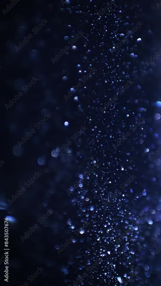 Blue sparkle particles with bokeh effect, abstract background. Vertical video. Blue sparkle particles with bokeh effect, abstract background. Vertical video.