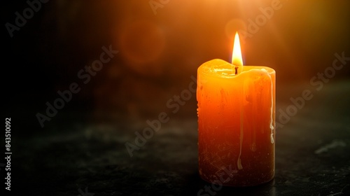 A flickering candle in the midst of darkness, casting gentle light