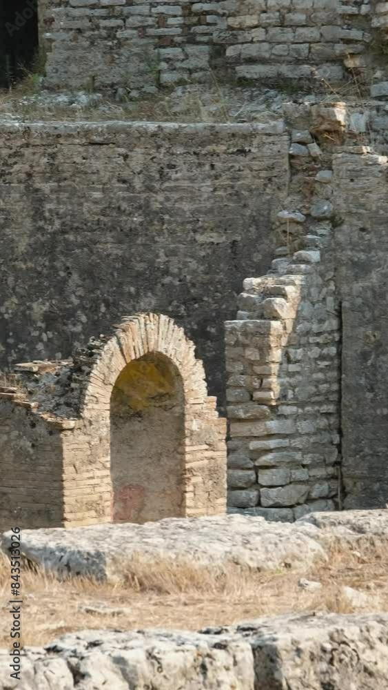 A tourist visiting The Great Basilica in the archaeological ruins of Butrint or Butrinto National Park in Albania. A tourist visiting The Great Basilica in the archaeological ruins of Butrint or Butrinto National Park in Albania.