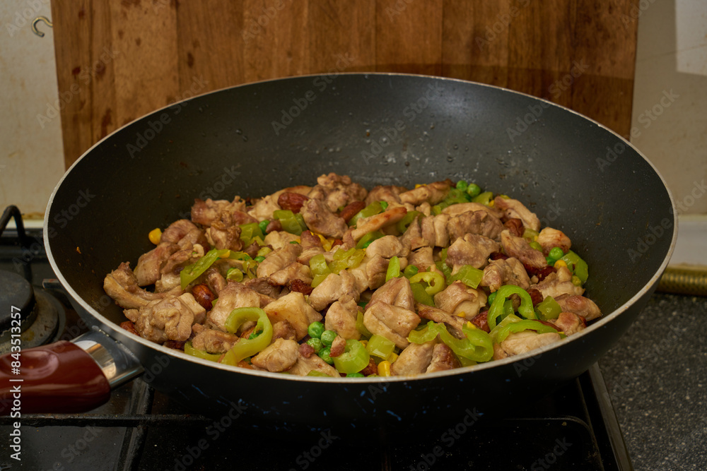 Chinese fried chicken with vegetables in wok frying pan Chinese fried chicken with vegetables in wok frying pan