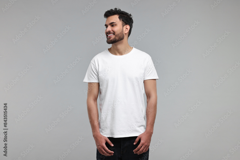 Smiling man in white t-shirt on grey background Smiling man in white t-shirt on grey background