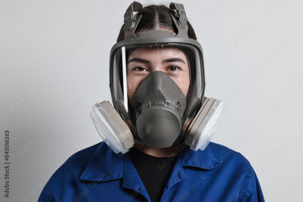 Worker in respirator mask on grey background Worker in respirator mask on grey background