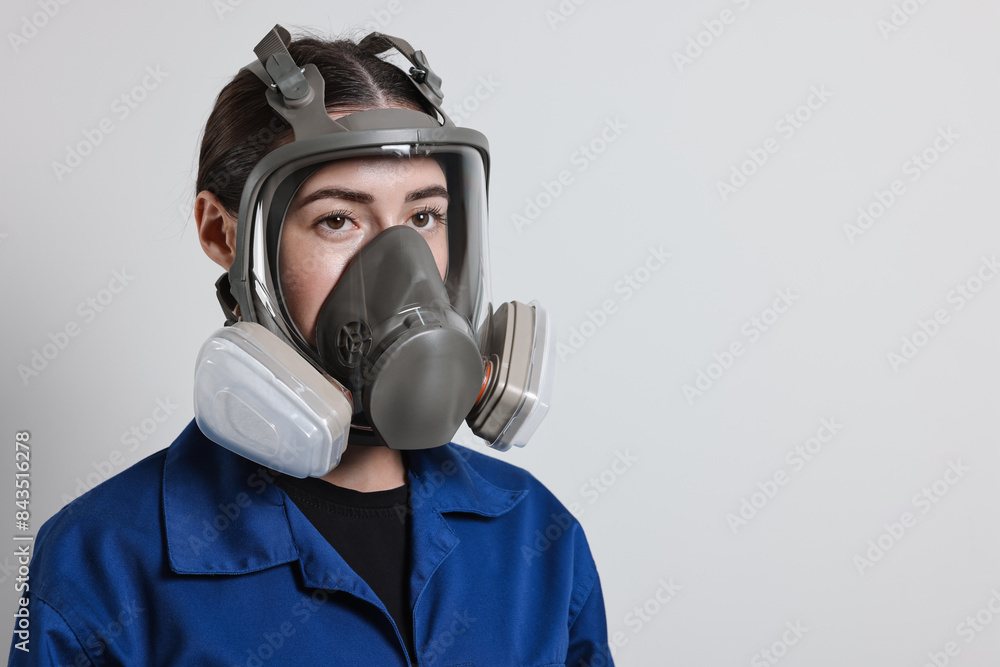 Worker in respirator on grey background, space for text Worker in respirator on grey background, space for text
