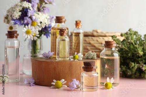 Wallpaper Mural Aromatherapy. Different essential oils and flowers on pink wooden table Torontodigital.ca