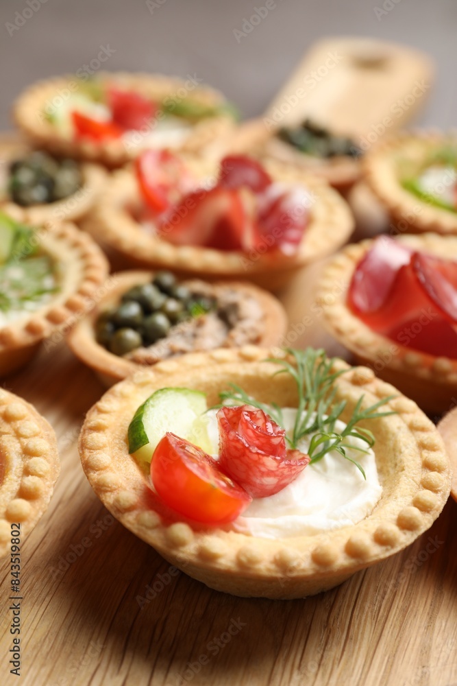 Delicious canapes with dry smoked sausage and cream cheese on table, closeup Delicious canapes with dry smoked sausage and cream cheese on table, closeup