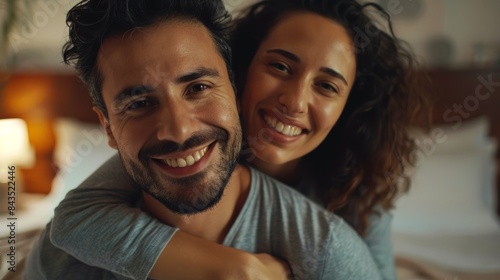 Couple photo and hug in bedroom, smiling and loving, caring and trusting in healthy relationship. Interracial folks are happy, romantic, and married.