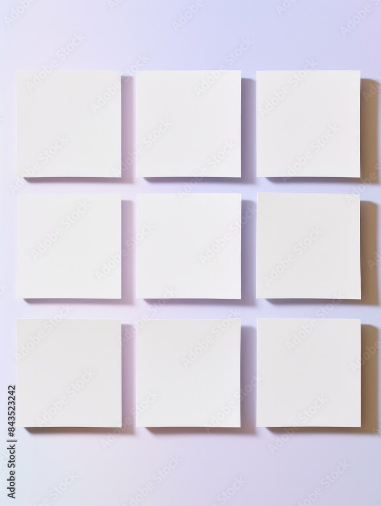 Fototapeta premium Nine evenly spaced blank white canvases against a purple wall give a sense of gallery-ready potential