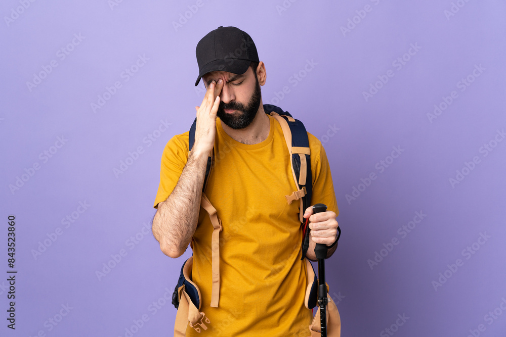 Caucasian handsome man with backpack and trekking poles over isolated background with headache Caucasian handsome man with backpack and trekking poles over isolated background with headache