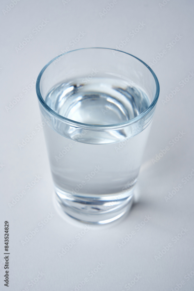 Small water glass on a white background. Small water glass on a white background.