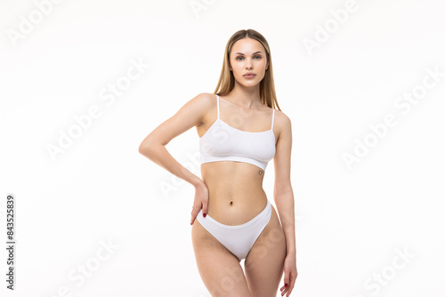 Young nice lady woman with slim body perfect white lingerie stand hold hands crossed on white background.