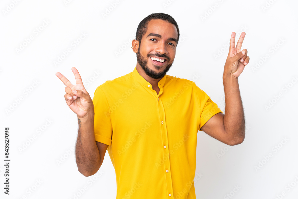 Young Ecuadorian man isolated on white background showing victory sign with both hands Young Ecuadorian man isolated on white background showing victory sign with both hands