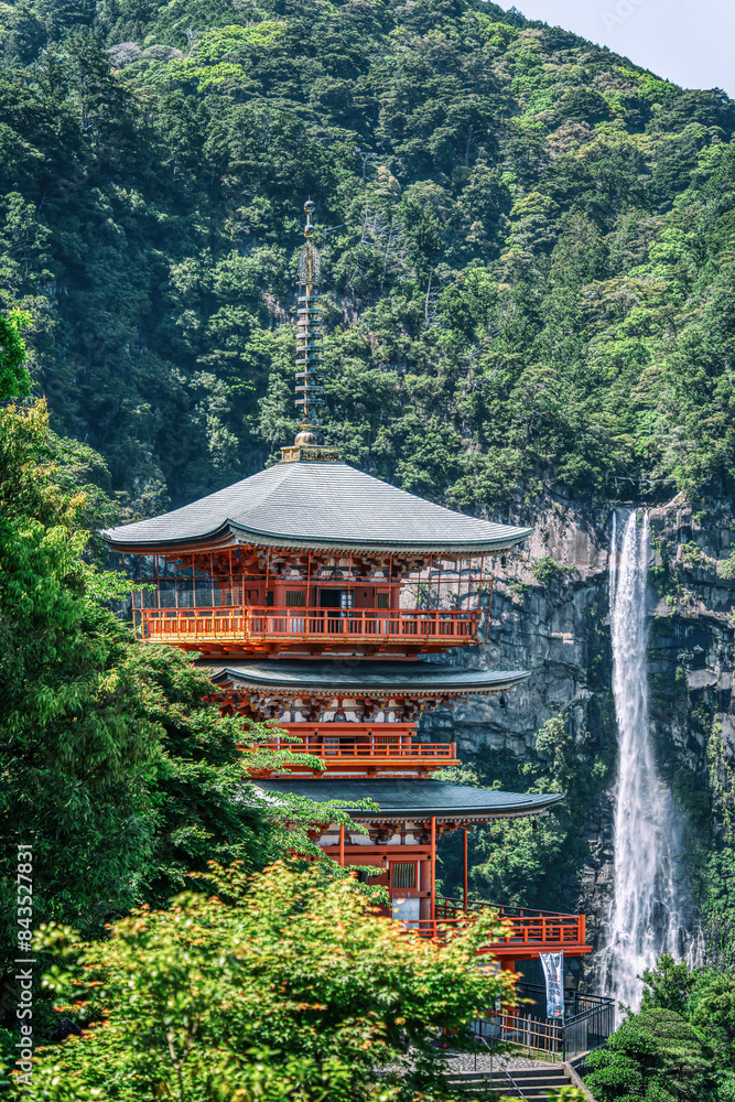 The red three-story pagoda of Seigantoji Buddhist Temple in front of Nachi Falls. Beautiful natural scenery in Nachikatsuura, Japan The red three-story pagoda of Seigantoji Buddhist Temple in front of Nachi Falls. Beautiful natural scenery in Nachikatsuura, Japan