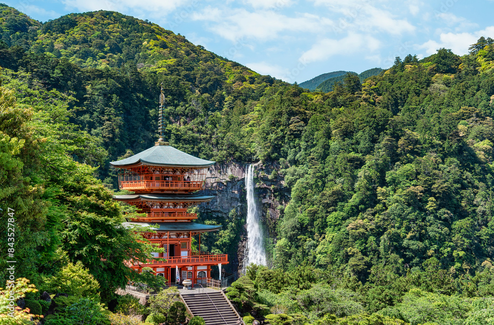 The red three-story pagoda of Seigantoji Buddhist Temple in front of Nachi Falls. Beautiful natural scenery in Nachikatsuura, Japan The red three-story pagoda of Seigantoji Buddhist Temple in front of Nachi Falls. Beautiful natural scenery in Nachikatsuura, Japan