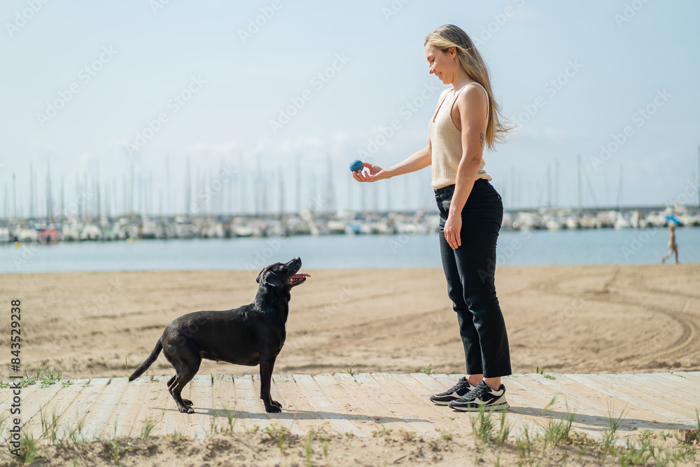 Young blonde woman with her dog at outdoors Young blonde woman with her dog at outdoors