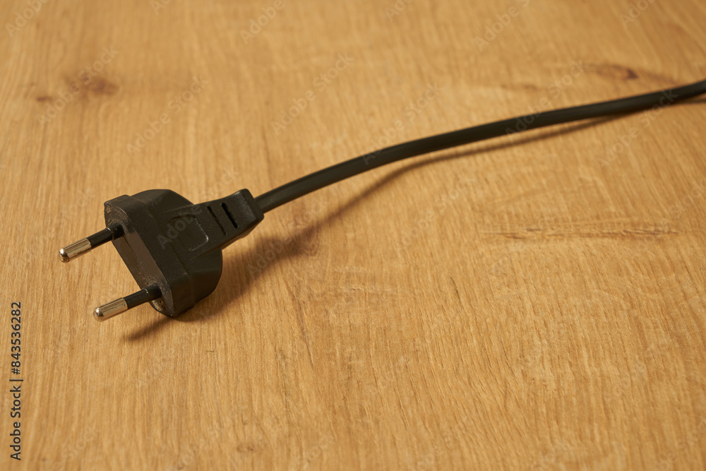 Black electrical euro plug on a table Black electrical euro plug on a table