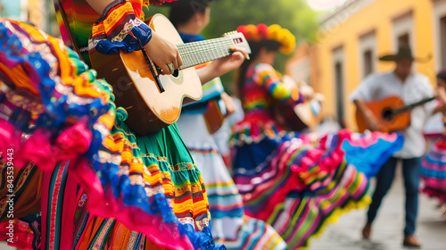 Mexican traditional dance and music performance in colorful costumes, closeup of guitar players during fiesta parade on street background.