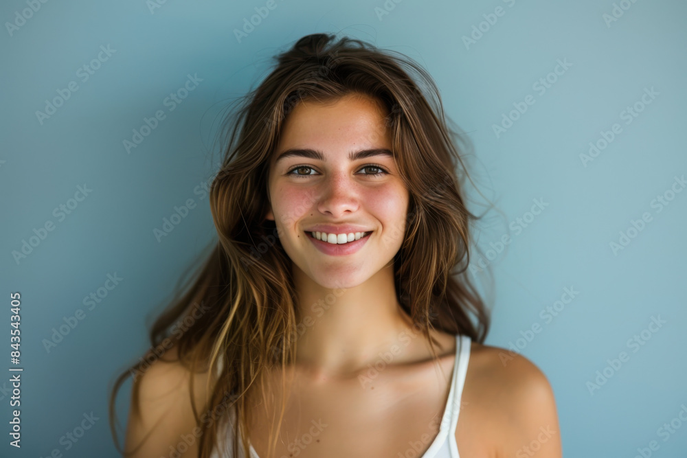 A close up portrait of a young woman with a subtle smile A close up portrait of a young woman with a subtle smile