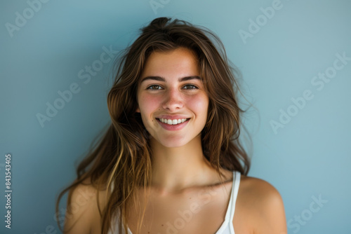 A close up portrait of a young woman with a subtle smile