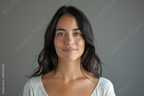 A close up portrait of a young woman with a subtle smile