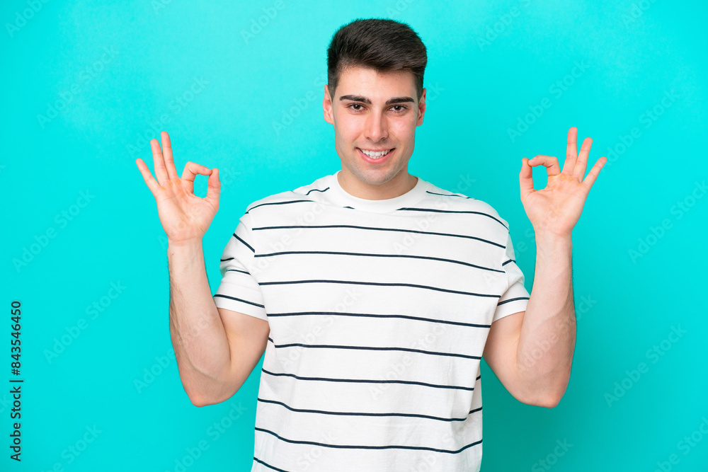 Young caucasian man isolated on blue background in zen pose Young caucasian man isolated on blue background in zen pose