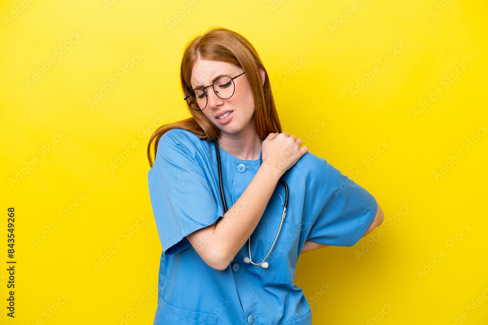 Young redhead nurse woman isolated on yellow background suffering from pain in shoulder for having made an effort Young redhead nurse woman isolated on yellow background suffering from pain in shoulder for having made an effort