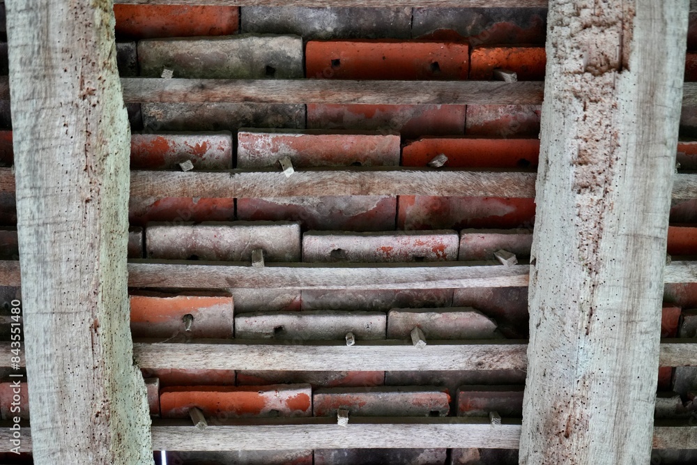 Traditional English Tudor tiled roof construction details, with woodworm holes in the timber. Traditional English Tudor tiled roof construction details, with woodworm holes in the timber.