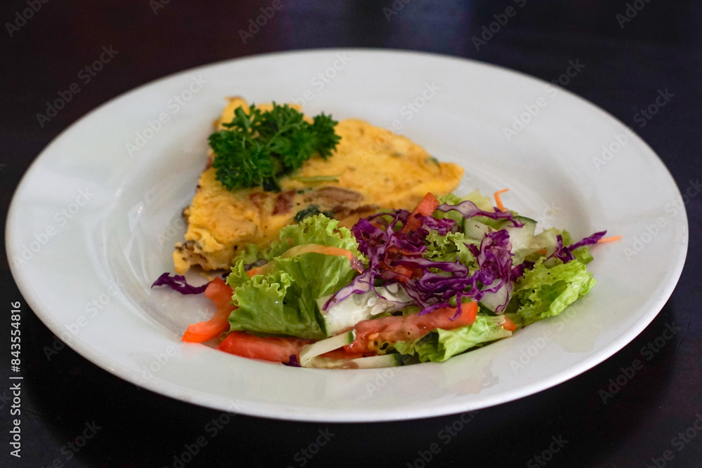 Omelet with vegetable salad on a white plate Omelet with vegetable salad on a white plate