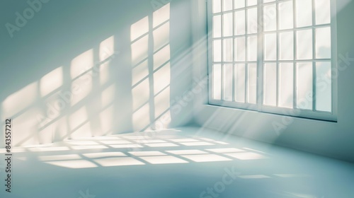 Sunlight streaming through a window casting geometric shadows on the wall and floor. Minimalist and serene indoor lighting concept.