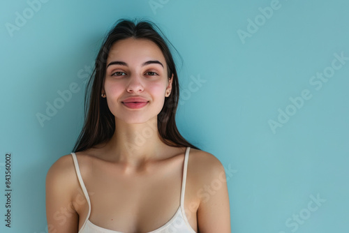 A close up portrait of a young woman with a subtle smile
