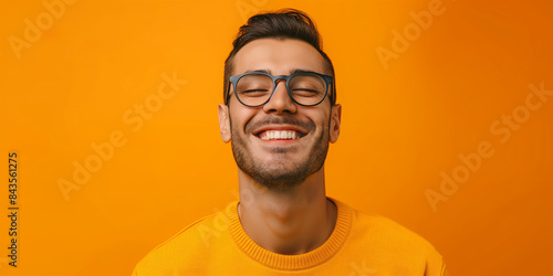 A man with glasses and a yellow shirt
