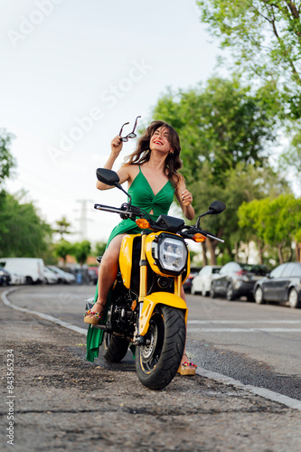 An attractive young woman sitting on her motorcycle © Miguel Lifestyle