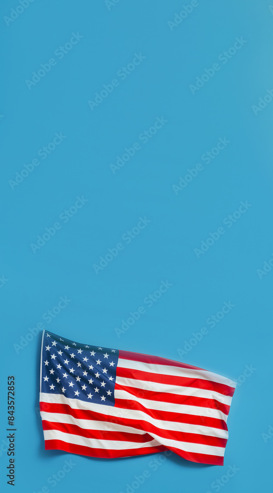 Obraz premium American flag against blue background, US flag is at bottom of frame, vertical banner with copy space for patriotism, national pride, national holidays, political events