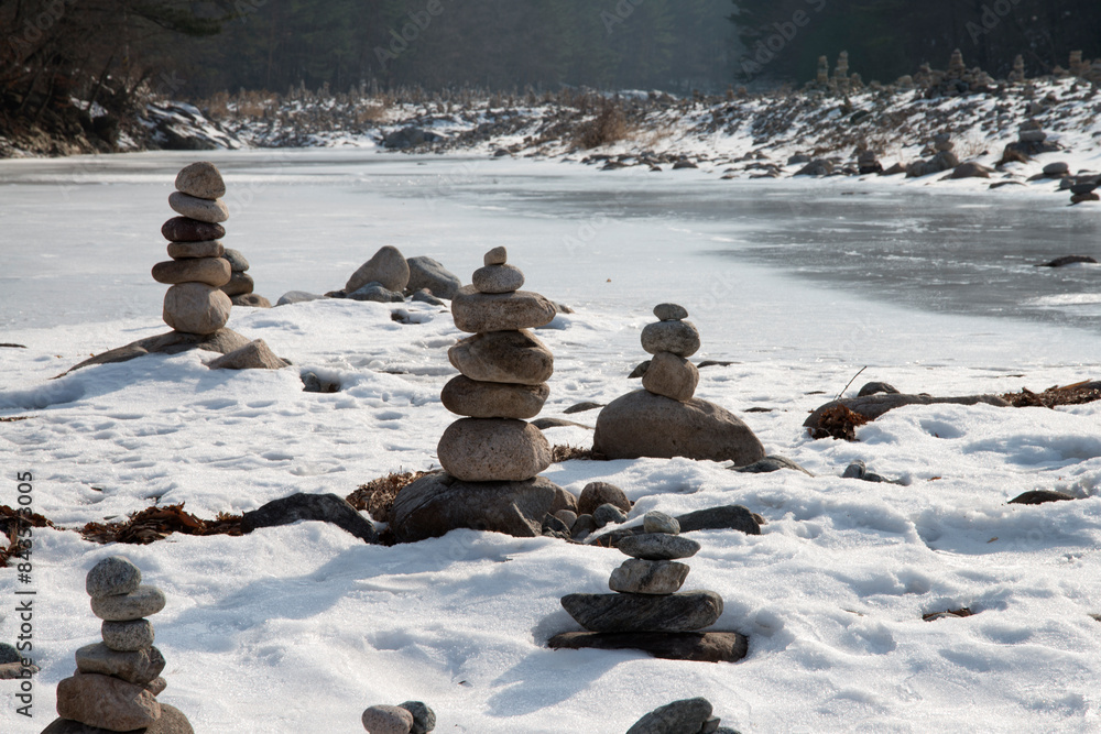 The tower of pebble stack on the side of stream