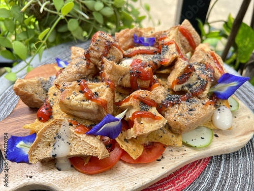 Fried tofu mixed sesame with tomato sauce photo