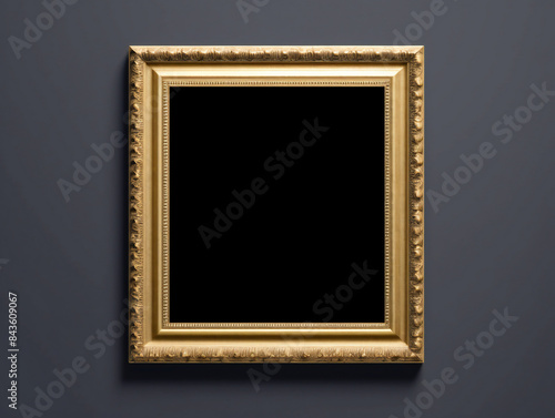 A classic gold picture frame hanging on a neutral gray wall. © Darcraft