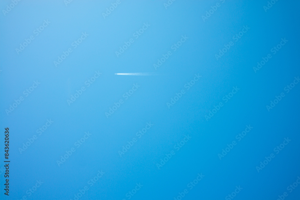 An airplane flies through the blue sky, leaving behind a white aircraft trail.This photo is suitable for making blue background material.
An airplane flies through the blue sky, leaving behind a white aircraft trail.This photo is suitable for making blue background material.