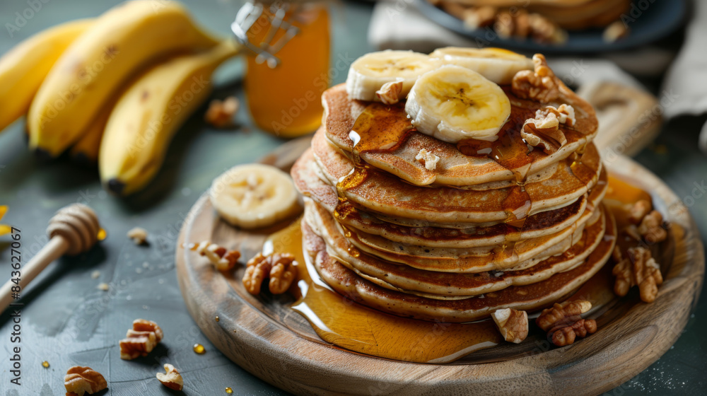 A stack of pancakes with bananas and walnuts on top of a wooden board A stack of pancakes with bananas and walnuts on top of a wooden board