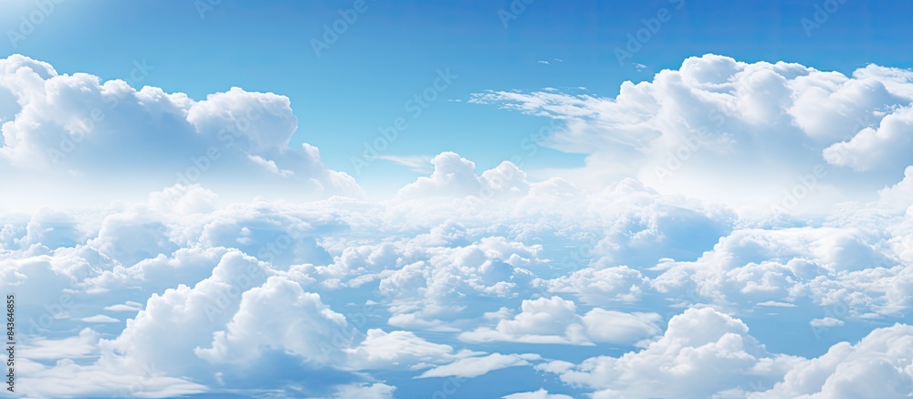 The sky with its expansive blue hue and scattered white clouds stretches across the copy space image The sky with its expansive blue hue and scattered white clouds stretches across the copy space image