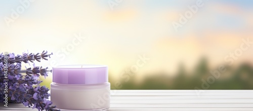 A cosmetic cream jar and fresh lavender flowers are showcased on a white wooden table providing an inviting and visually appealing copy space image
