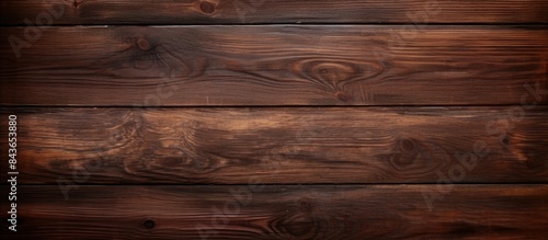A vintage dark brown wooden texture creates a captivating copy space image for a wood background