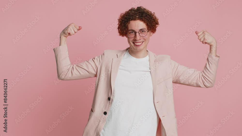 I am strong and independent. Caucasian curly haired man in jacket showing biceps and looking confident, feeling power strength to fight for rights, energy to gain success win. Guy on pink background I am strong and independent. Caucasian curly haired man in jacket showing biceps and looking confident, feeling power strength to fight for rights, energy to gain success win. Guy on pink background
